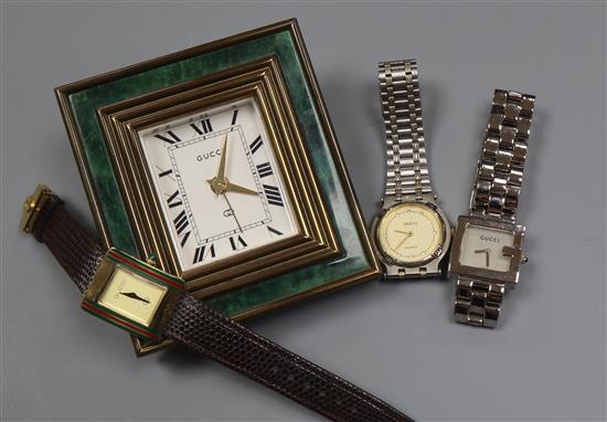 A Gucci travelling desk clock and three Gucci wrist watch including 925.